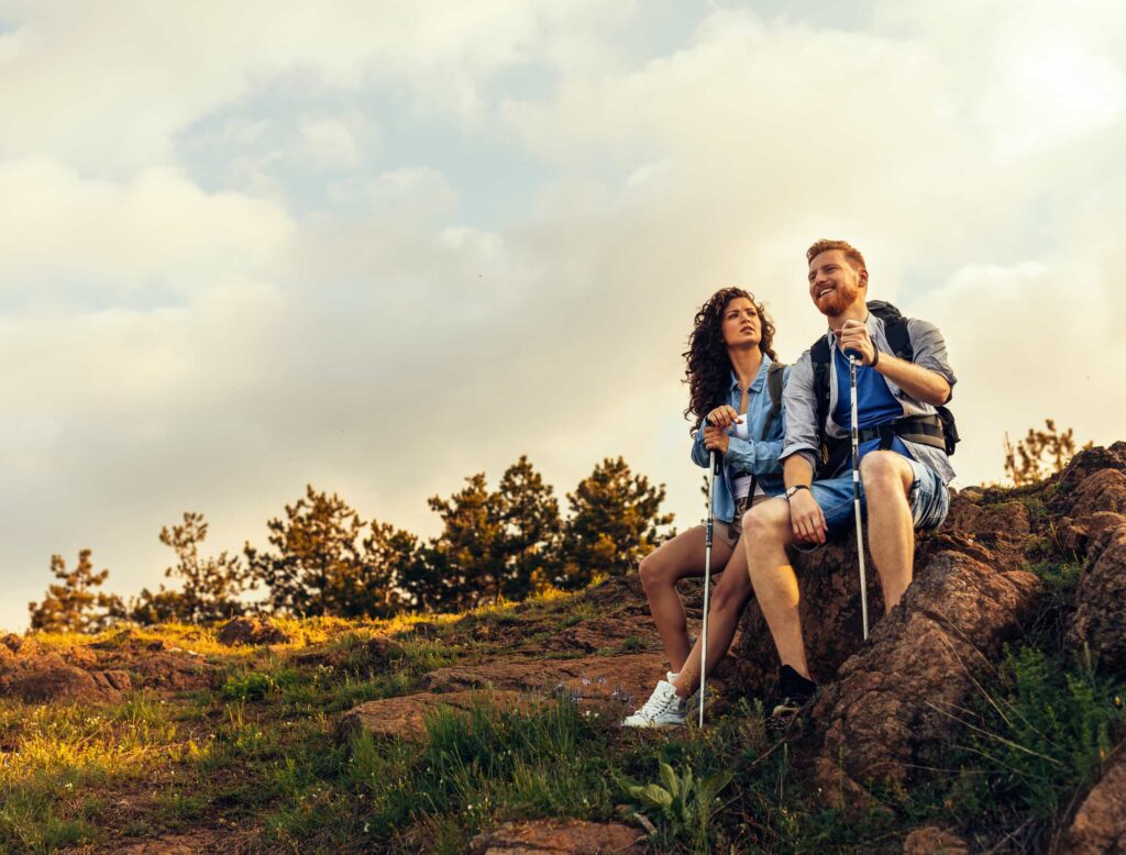 Couple resting on a hillside during a hike