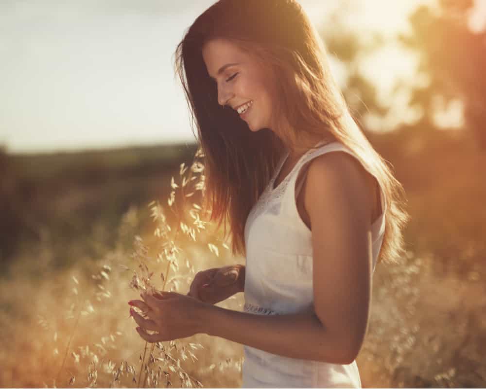 Woman smiling in a sunlit field