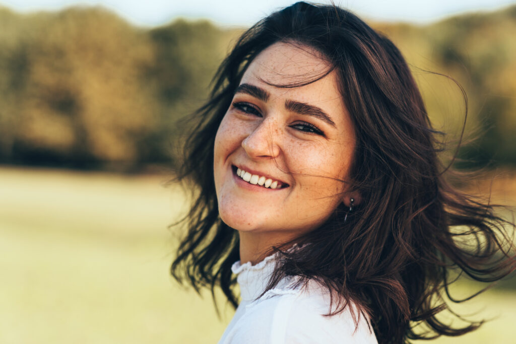 Smiling woman outdoors on a sunny day